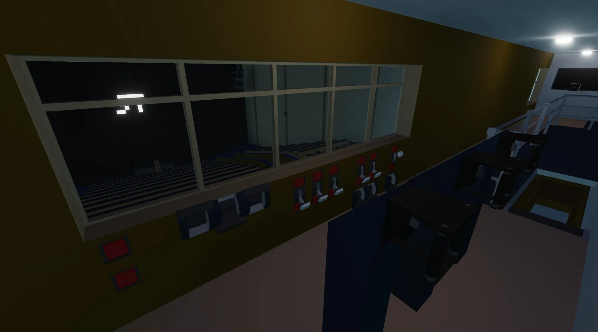 The tech booth behind the auditorium, with various equipment and controls for managing the theater experience.